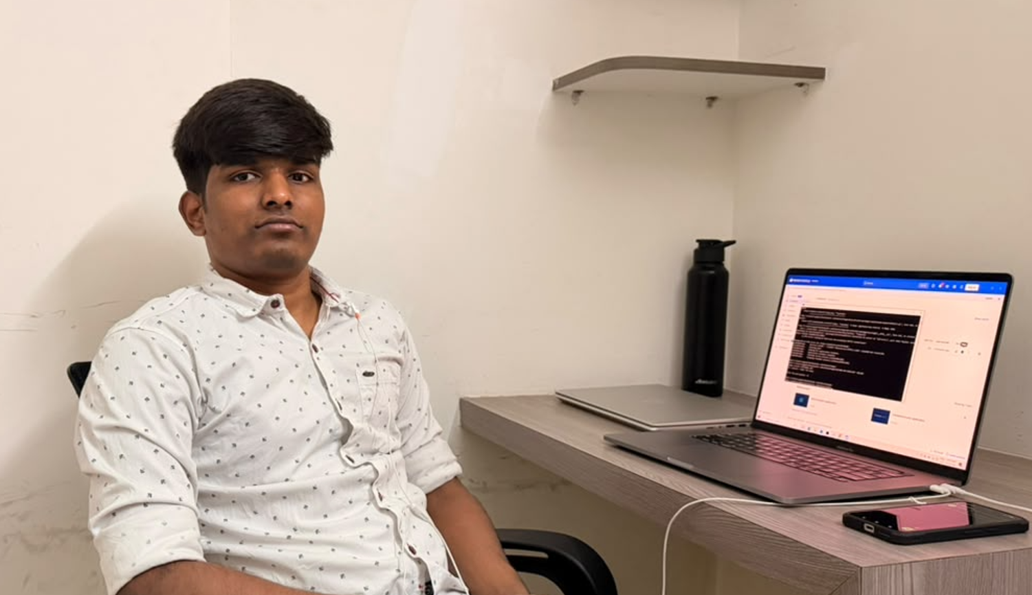Sugumar S at his development workstation writing code